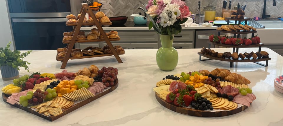 Charcuterie spread with pastries, fruit and dessert tiers